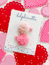 Load image into Gallery viewer, delphinette handmade felt little girl/baby girl hair accessory - a little carnation pink yarn pom pom and a light rose pink yarn pom pom that can be customized as a hair clip, headband or hair tie. Handmade in Canada.