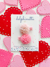 Load image into Gallery viewer, delphinette handmade felt little girl/baby girl hair accessory - a little carnation pink yarn pom pom and a light rose pink yarn pom pom that can be customized as a hair clip, headband or hair tie. Handmade in Canada.