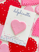 Load image into Gallery viewer, delphinette handmade felt little girl/baby girl hair accessory - a vintage inspired pink felt heart with little heart cutouts that can be customized as a hair clip, headband or hair tie. Handmade in Canada.