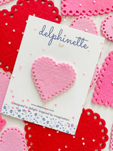 Load image into Gallery viewer, delphinette handmade felt little girl/baby girl hair accessory - a vintage inspired pink felt heart with little heart cutouts that can be customized as a hair clip, headband or hair tie. Handmade in Canada.