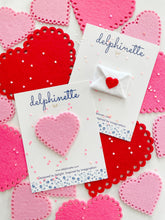 Load image into Gallery viewer, delphinette handmade felt little girl/baby girl hair accessory - a vintage inspired pink felt heart with little heart cutouts that can be customized as a hair clip, headband or hair tie. Handmade in Canada. 
