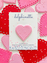 Load image into Gallery viewer, delphinette handmade felt little girl/baby girl hair accessory - a vintage inspired pink felt heart with little heart cutouts that can be customized as a hair clip, headband or hair tie. Handmade in Canada. 
