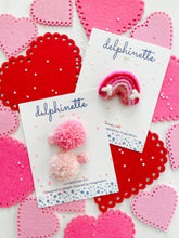 Load image into Gallery viewer, delphinette handmade felt little girl/baby girl hair accessory - a little carnation pink yarn pom pom and a light rose pink yarn pom pom that can be customized as a hair clip, headband or hair tie. Handmade in Canada.
