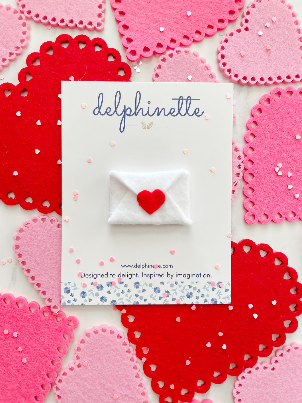 delphinette handmade felt little girl/baby girl hair accessory - a little white felt enveloped sealed with a little red heart that can be customized as a hair clip, headband or hair tie. Handmade in Canada.